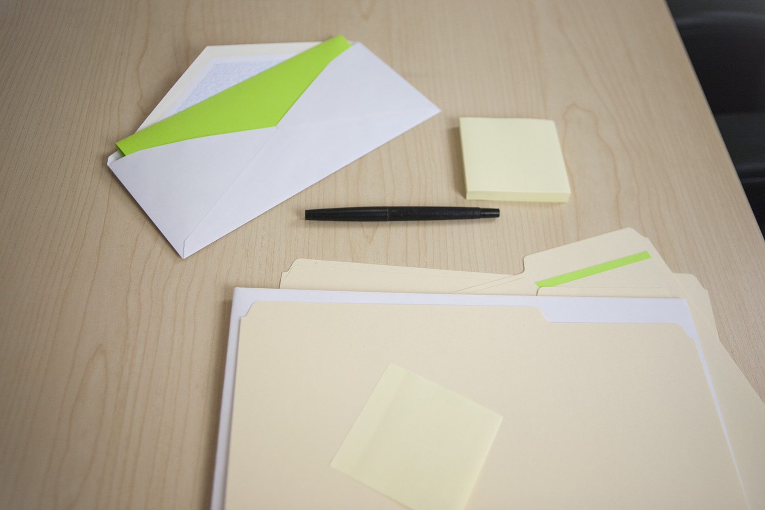 Manila folder, envelope, and some other office supplies on desk. Manila folder, envelope, and some other office supplies on desk.